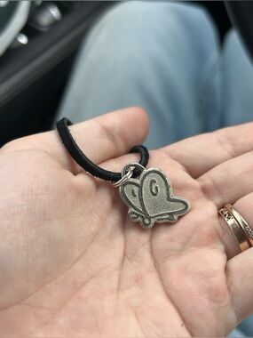 black necklace with silver butterfly charm